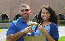 Photo of students holding a Mercy College bag. Link to Gifts of Real Estate.